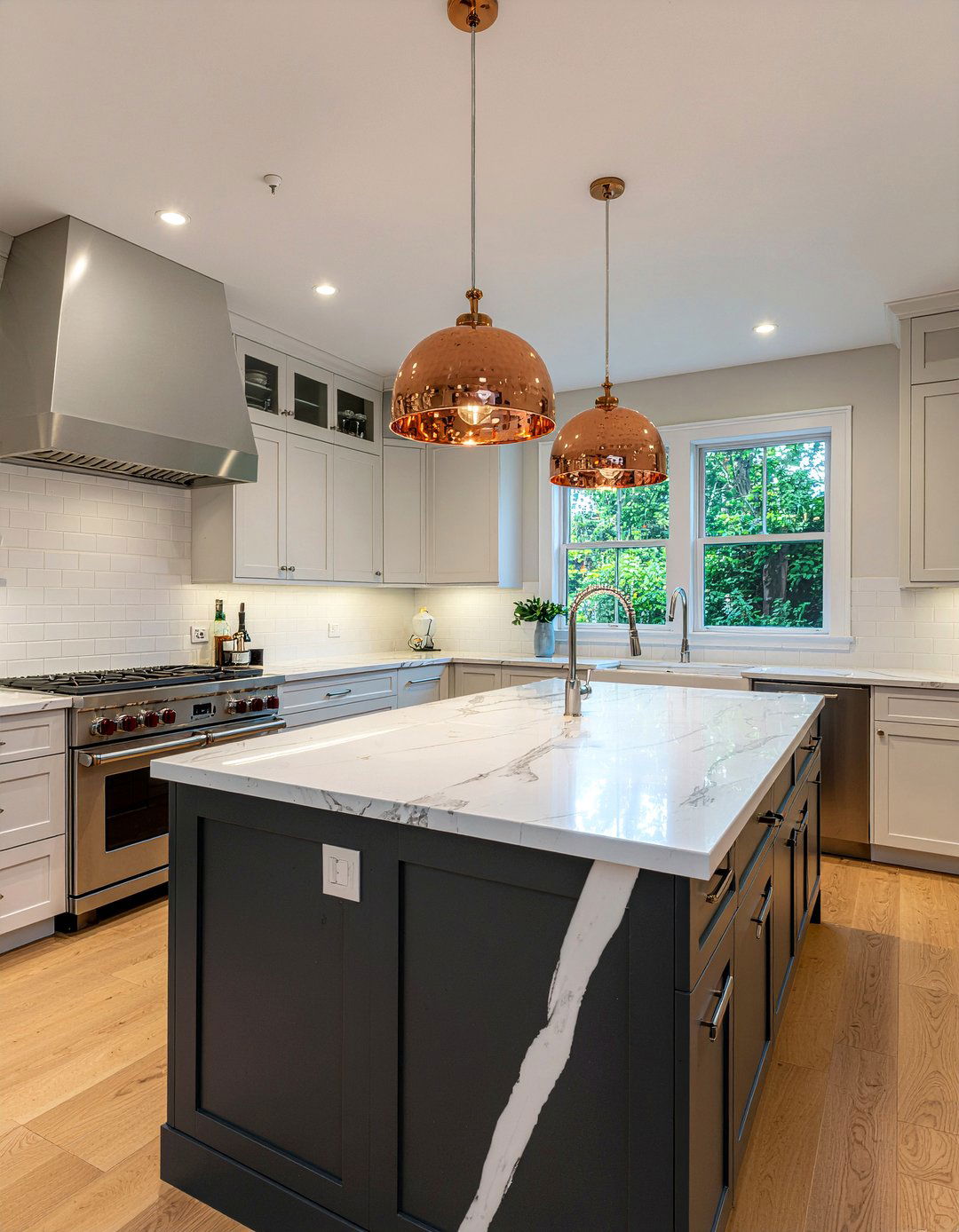 Copper pendant lights and silver faucets - 30 mixed metal kitchen ideas