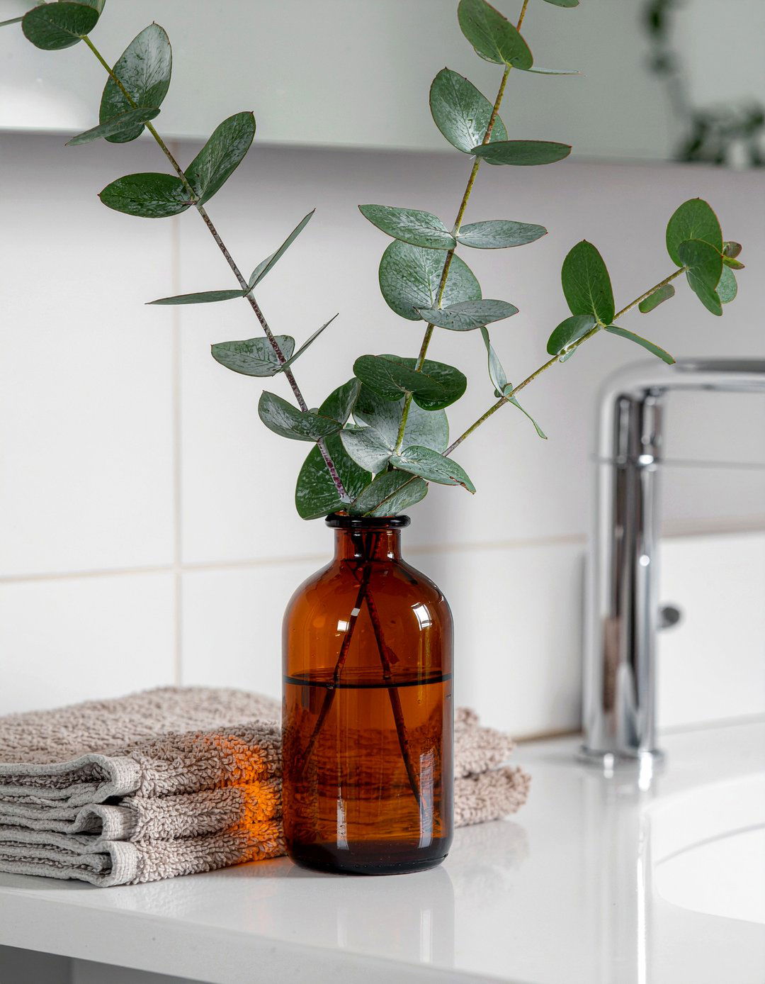 Eucalyptus in glass bottle - 30 bathroom countertop styling ideas