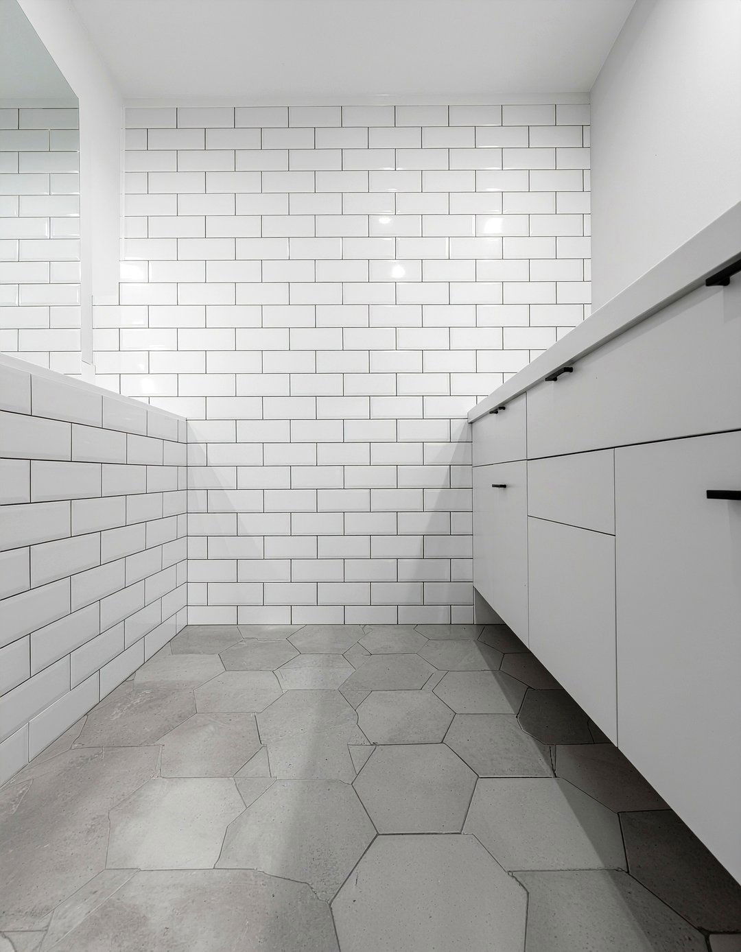 Hexagon floor and subway tile wall - 30 bathroom pattern mixing ideas