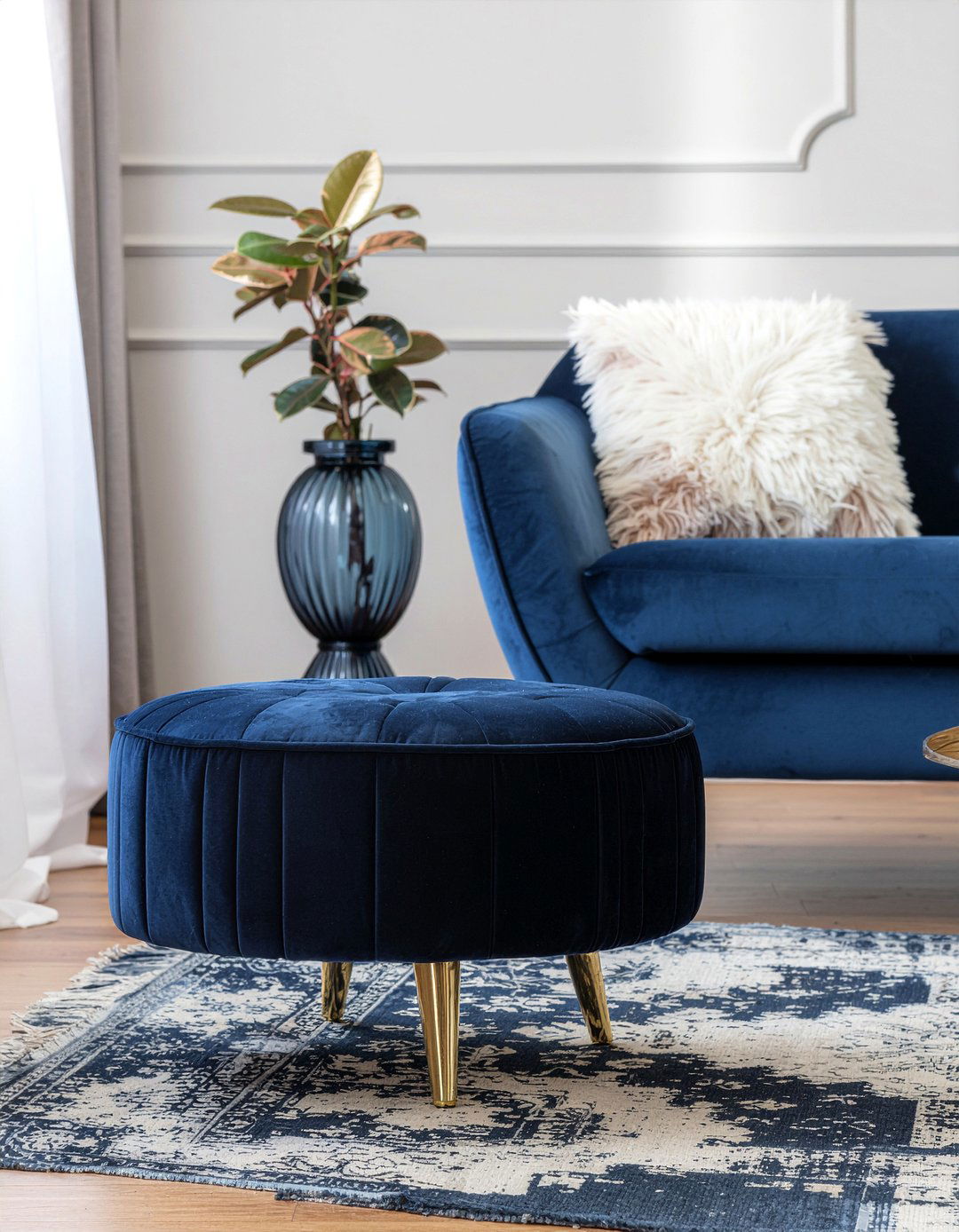 Navy blue ottoman with gold base - 30 navy and gold living room ideas