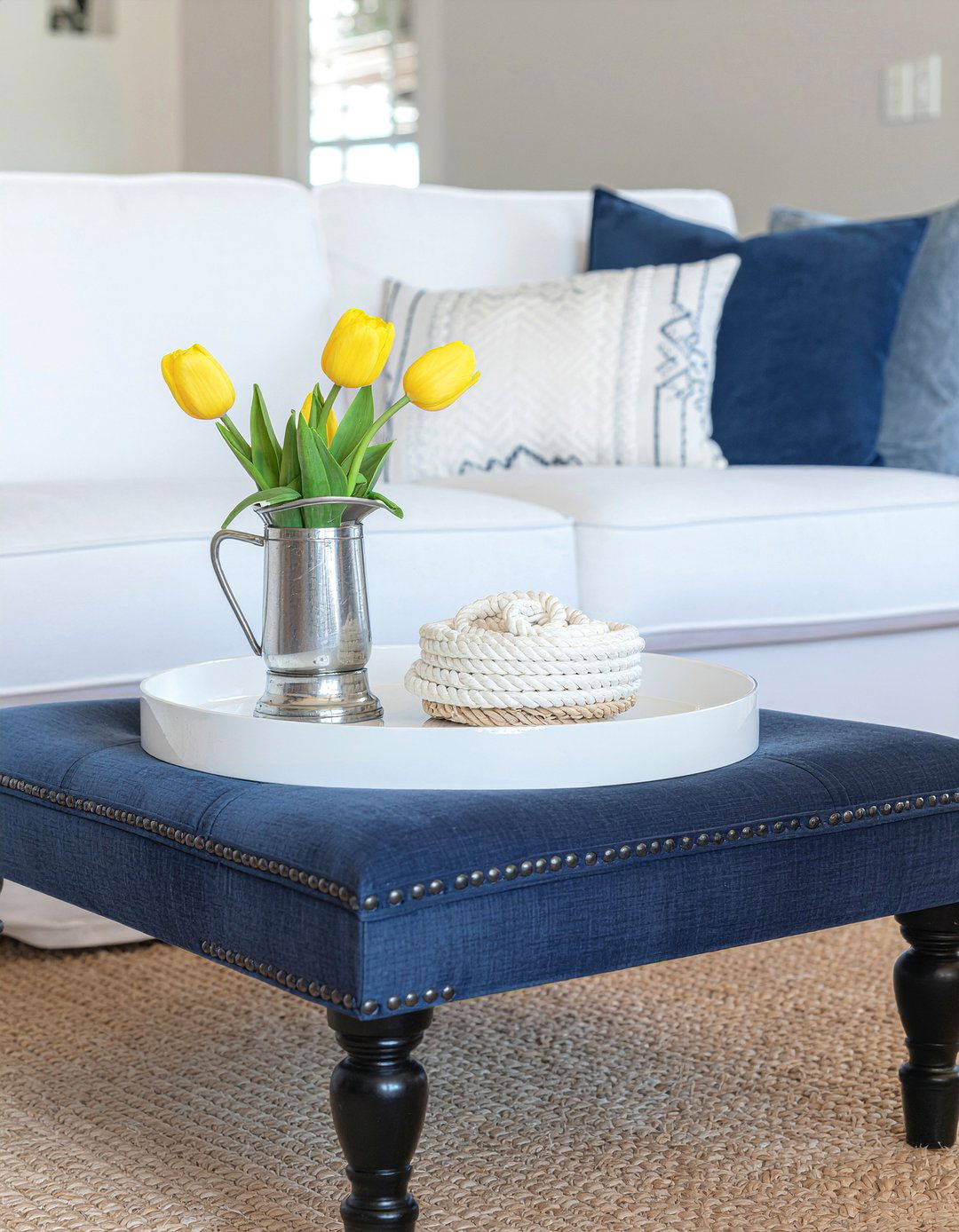 White lacquer tray on navy ottoman - 30 living room tray ottoman ideas